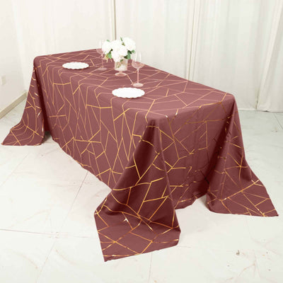 Geometric patterned tablecloth in burgundy with gold accents.