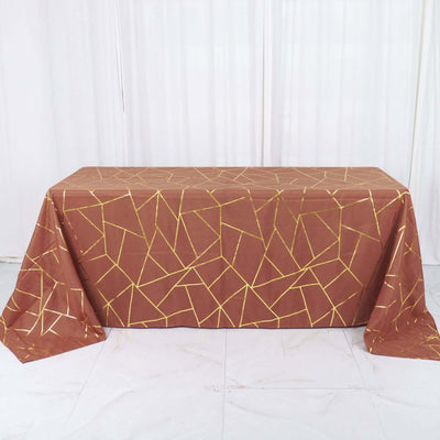 Brown tablecloth with gold geometric pattern, styled for events or decor.