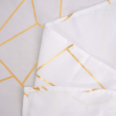 Geometric patterned tablecloth with gold accents on a white background.