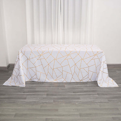 White tablecloth with gold geometric pattern on a gray floor