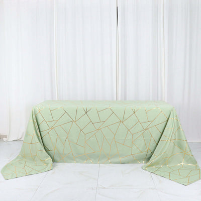 Mint green tablecloth with gold geometric pattern on a white backdrop.