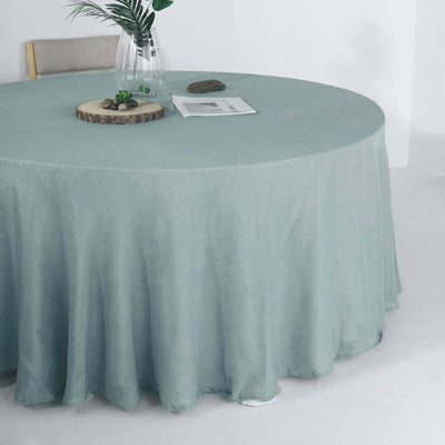 Round mint green tablecloth draping elegantly over a circular table.