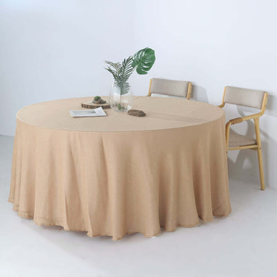 Round beige tablecloth draped over a table with minimalist decor