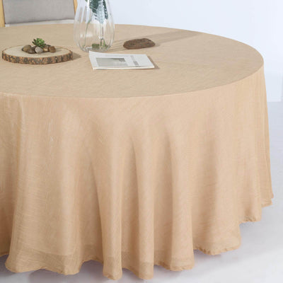 Round beige tablecloth draped over a table with decorative elements