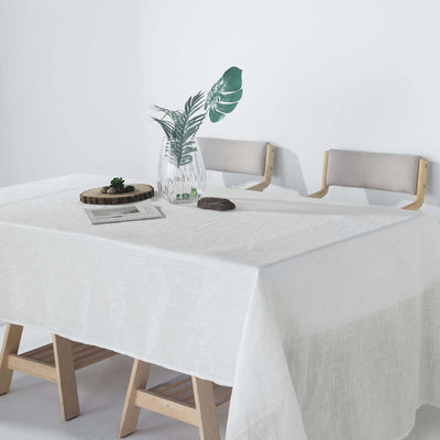 White tablecloth draped over a wooden table with decorative elements