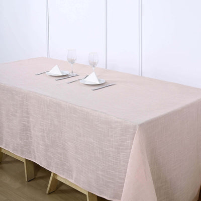 Elegant beige tablecloth set for dining, featuring plates and glasses.