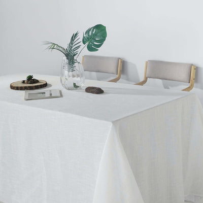 Elegant dining table setup with a stylish tablecloth and decor.