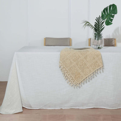 Linen tablecloth with intricate crochet detailing on a dining table