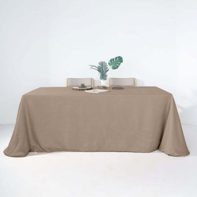 Beige tablecloth draped elegantly over a dining table.