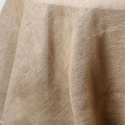 Textured beige fabric draped softly on a surface.