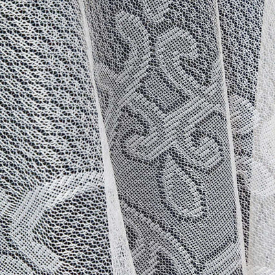 White lace fabric with intricate pattern details.