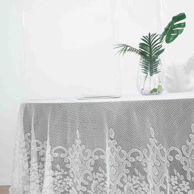 Lace tablecloth draped elegantly over a table with a vase and plant