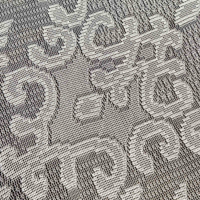 Textured lace fabric in intricate floral pattern.