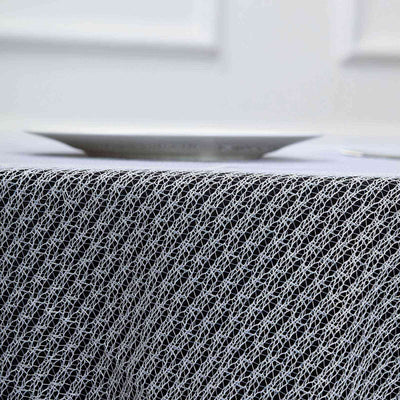 Textured black and white tablecloth with intricate mesh design.