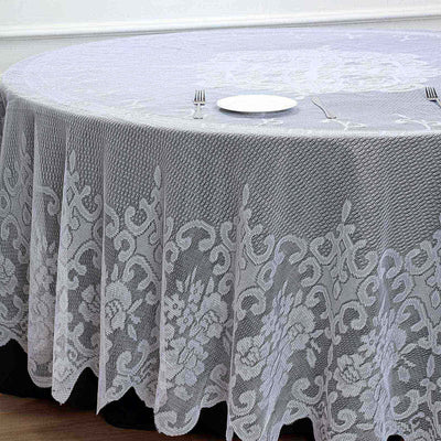 Round lace tablecloth in light gray on a dining table setting.