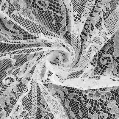 White lace fabric swirled in a delicate pattern.