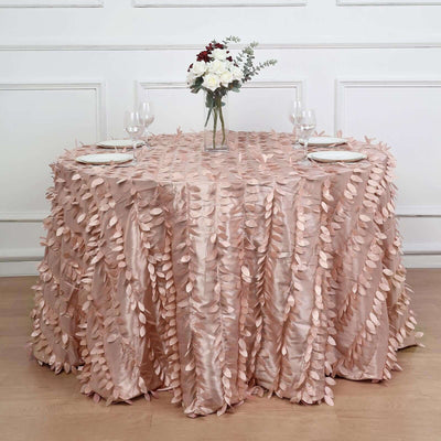 Elegant pink tablecloth with leaf-like embellishments on a dining table.