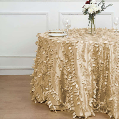 Gold leaf tablecloth draped elegantly over a round table in a styled setting.