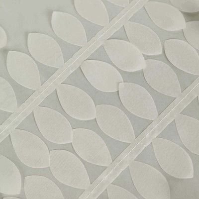 Textured fabric with leaf patterns in soft neutral tones.