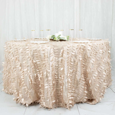 Elegant beige tablecloth with leaf embellishments on a round table.