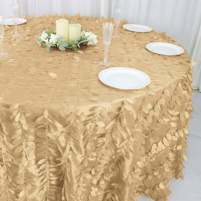 Gold tablecloth with leaf design on a round table set for dining.
