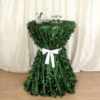 Green leaf table skirt with white ribbon for elegant events.