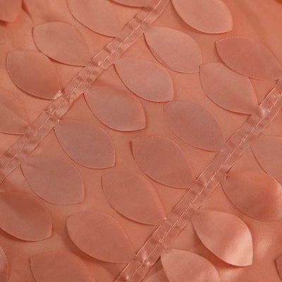 Coral fabric with leaf-shaped appliqués in a textured design.
