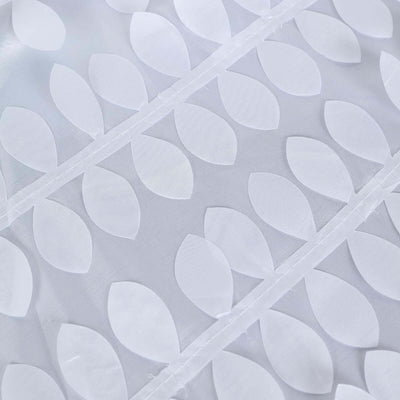 White fabric with leaf pattern design, showcasing texture and detail.