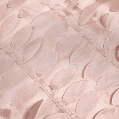 Textured blush fabric with leaf patterns for upholstery or crafting.