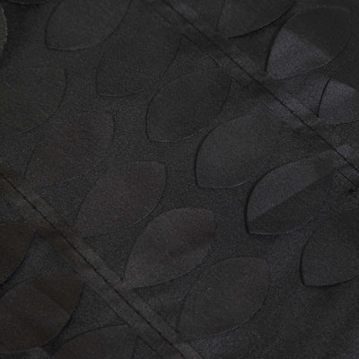 Black fabric with embossed leaf pattern detail.