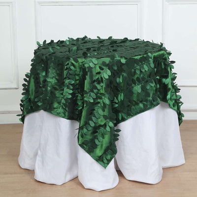 Green leaf-patterned tablecloth draped over a white table.