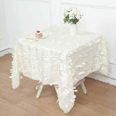 Elegant white tablecloth with textured leaf design on a wooden table.