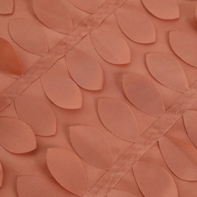Textured coral fabric with leaf patterns for upholstery or decor.