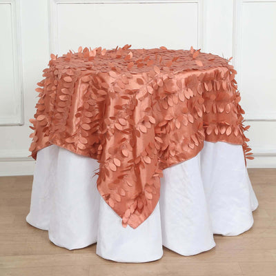 Rose gold tablecloth with leaf appliqué on a white table