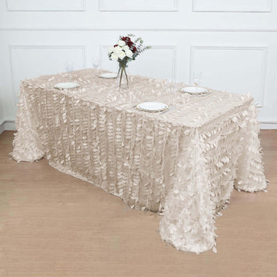 Elegant beige tablecloth with leaf embellishments, styled for a dining setup.