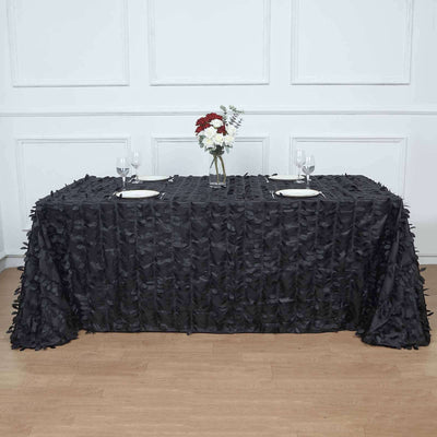 Black tablecloth with textured leaf design, styled for an elegant table setting.