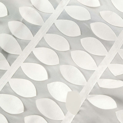 White fabric with leaf pattern design, showcasing texture and detail.
