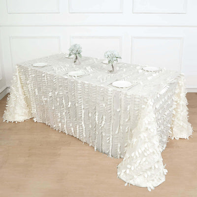 White tablecloth with textured ruffles on a decorated table setting.