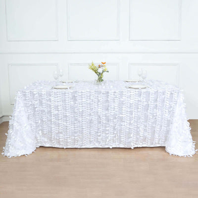 White tablecloth with textured ruffles, elegantly draped on a table.