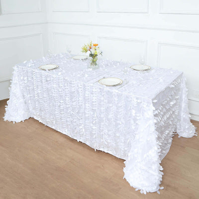 White tablecloth with floral design, elegantly draped over a dining table.