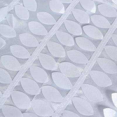 White fabric with leaf-shaped cutouts arranged in a pattern.