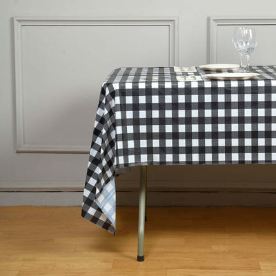 Black and white checkered tablecloth draped over a table in a dining setting.