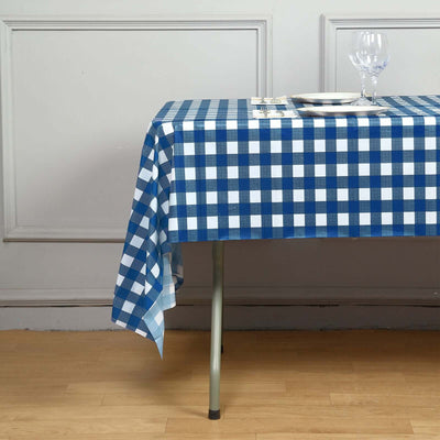 Navy and white checkered tablecloth draped over a table with glassware