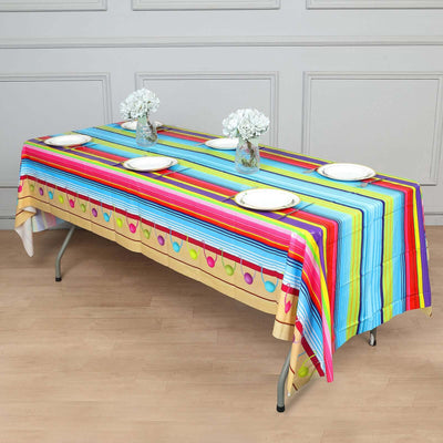 Colorful striped tablecloth with decorative patterns on a dining table.