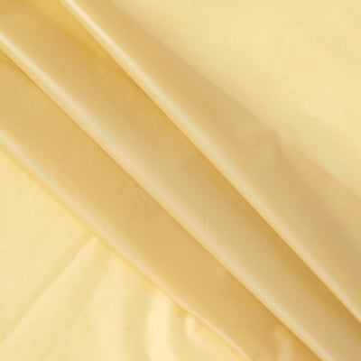 Yellow fabric rolls stacked neatly on a light surface.