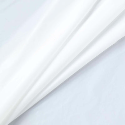 White fabric draped elegantly, showcasing soft textures and folds.