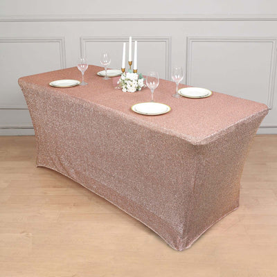 Sparkling rose gold tablecloth on a styled table setting with plates and glasses.