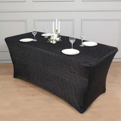 Black glitter tablecloth draped over a banquet table set for dining.