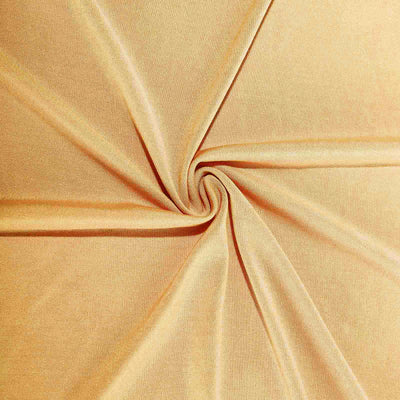Soft beige fabric with a smooth texture, elegantly arranged in a spiral.