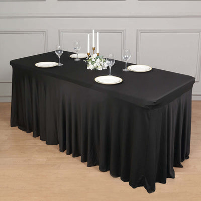 Elegant black tablecloth draped over a dining table set for a formal meal.
